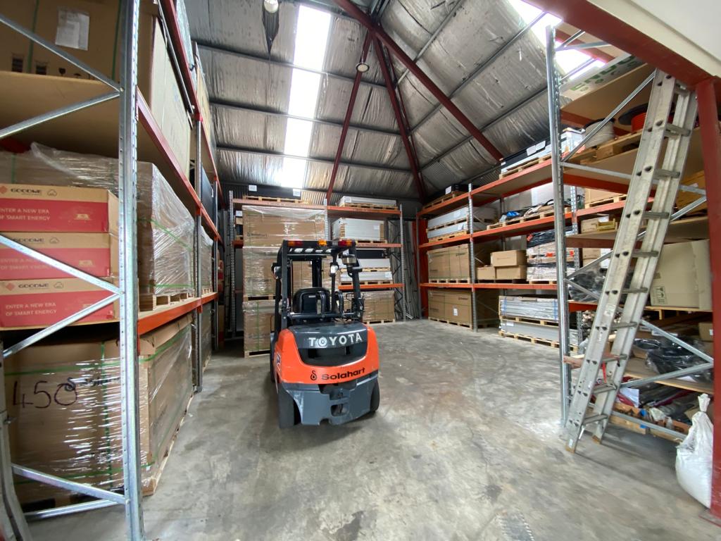 Inside the Solahart Darling Downs warehouse showing racking and forklift